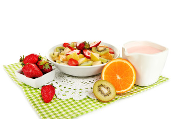 Useful fruit salad of fresh fruits and berries in bowl isolated