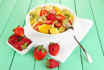 Useful fruit salad of fresh fruits and berries in bowl