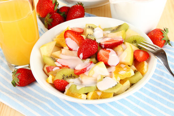 Useful fruit salad of fresh fruits and berries in bowl