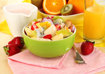 Useful fruit salad of fresh fruits and berries in bowl