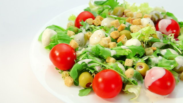 Salad with mozarella cheese and dressing