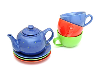 colorful tea cups with teapot isolated on white