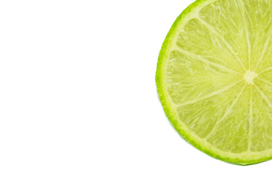 A slice of lime fruit over white background