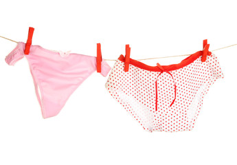 Women's panties hanging on rope isolated on white