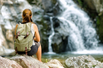 Female hiker looking at waterfall