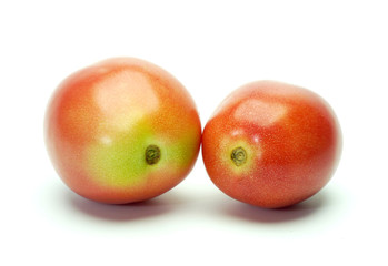 Two tomatoes on white background.