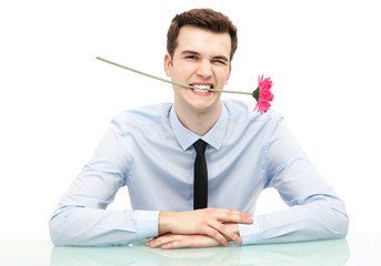 Businessman biting flower