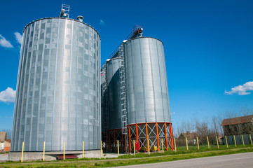 Silver Grain Silos with blue sky in background