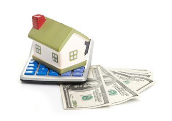 house sitting with a calculator and dollar