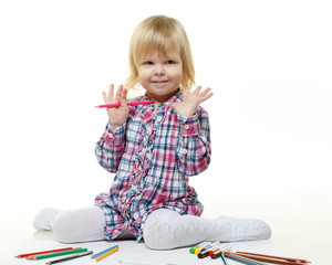 Happy little girl draws a picture.