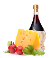 Red wine bottle, cheese and tomato still life