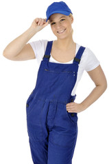 Junge freundliche Handwerkerin in Blaumann grüßt