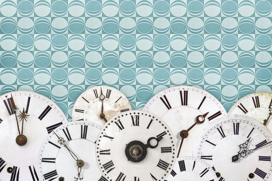 Set of vintage clock faces against a retro wallpaper background