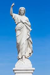Fototapeta premium Statue of a young woman raising a finger as a judgement sign