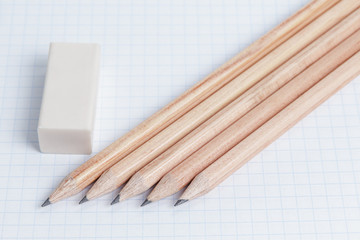 pencils and eraser on notebook page