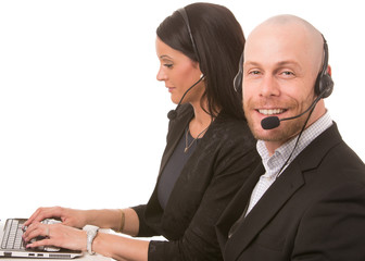 Businesswoman and businessman with headsets