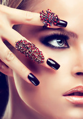 Model with burgundy manicure and fashion rings