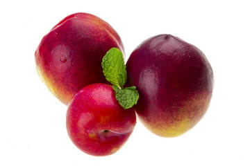 Ripe bright peaches, plum and mint