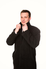 Handsome young businessman in a coat  isolated