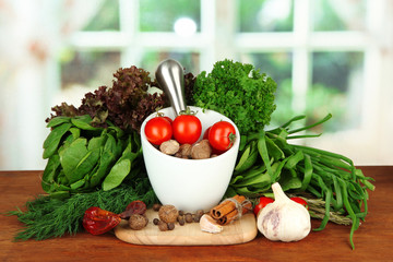 Composition of mortar, spices, tomatoes and  green herbs,