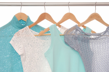 Summery blouses are on coat-hangers. © ludmilafoto
