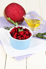 Sliced beetroot on bowl on wooden table close-up