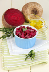 Sliced beetroot on bowl on wooden table close-up