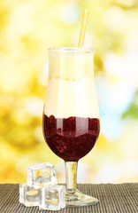 Delicious fruit smoothie on bright background