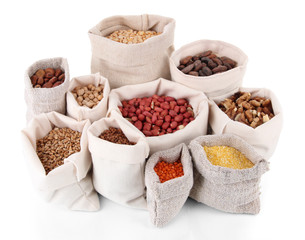 Different kinds of beans in sacks isolated on white