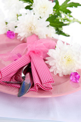 Served plate with napkin and flowers close-up