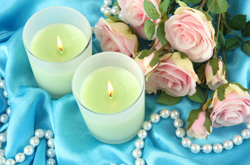 Candles on blue fabric close-up