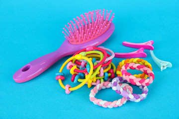 Scrunchies, hairbrush  and  hair - clip   on a blue background