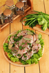 Chicken meat on wooden board,herbs and spices on wooden table