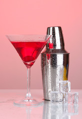 Cocktail shaker and cocktail on red background