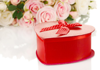 Beautiful gift on flowers background isolated on white