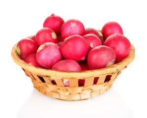 Small garden radish in wicker basket isolated on white