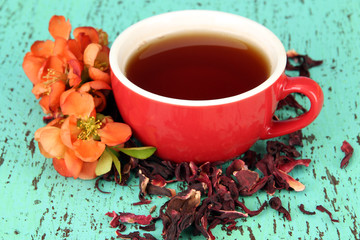 Herbal tea in cup, on color wooden background