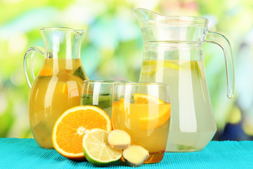 Orange and lemon lemonade in pitchers and glasses