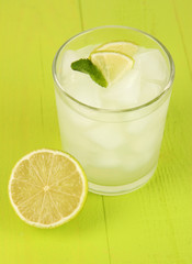 Lemonade in glass on wooden table close-up