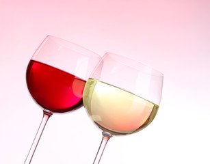 Glasses of wine on light pink tone