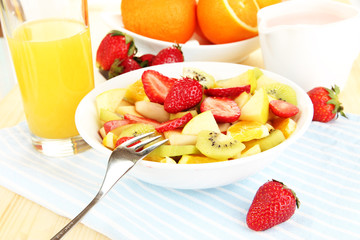 Useful fruit salad of fresh fruits and berries in bowl