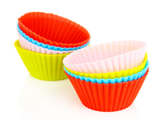 Stack of colorful cupcake cases isolated on white