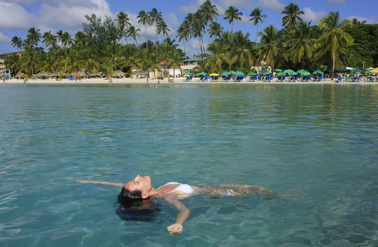 Young woman in bikini floating in clear water