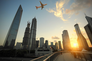 Fototapeta na wymiar Shanghai,Aircraft is flying in the modern urban buildings