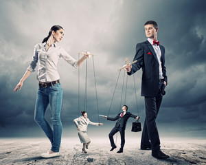 Businesspeople with marionettes