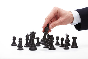 Business man moving chess figure