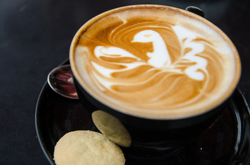 A cappuccino with a bird in latte art