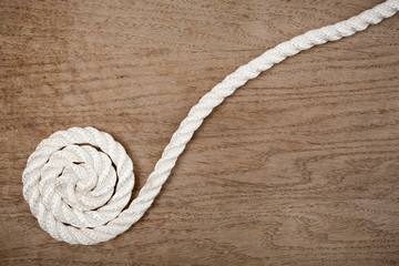 Nylon rope spiral on a wooden background