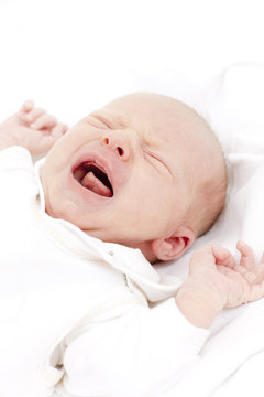 Portrait Of Crying Newborn Baby Girl