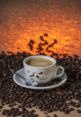 Coffee cup with coffee beans. Smoke.